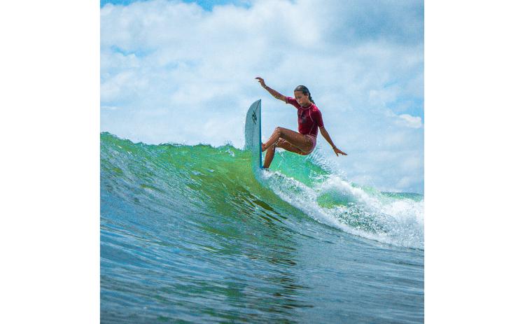 Fernandina Beach’s Mikaela Nichols rides a wave at a Main Beach competition, Aug. 24.  Photo by Southern Edge Studios