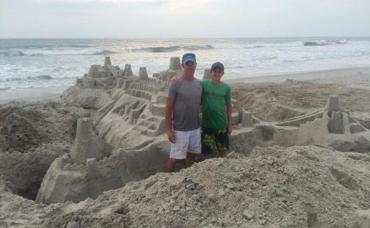 Greg Sheehan and son Christian In front of a sandcastle. Submitted Photos by Greg Sheehan 