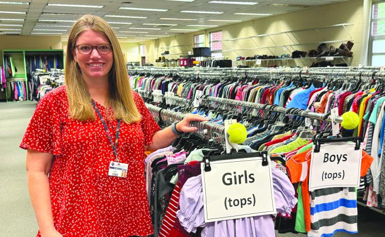 McKinney-Vento Program Manager Mollie Cressey stands at the front of the clothes closet, which is run by volunteers.