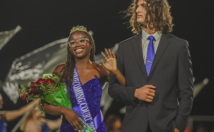Leyton Mezzio-Velardi escorts Passion Roberts, left, during the Fernandina Beach High School football halftime recognition of the homecoming court Friday. Roberts was crowned FBHS homecoming queen. Photo by Ashley Chandler/News-Leader