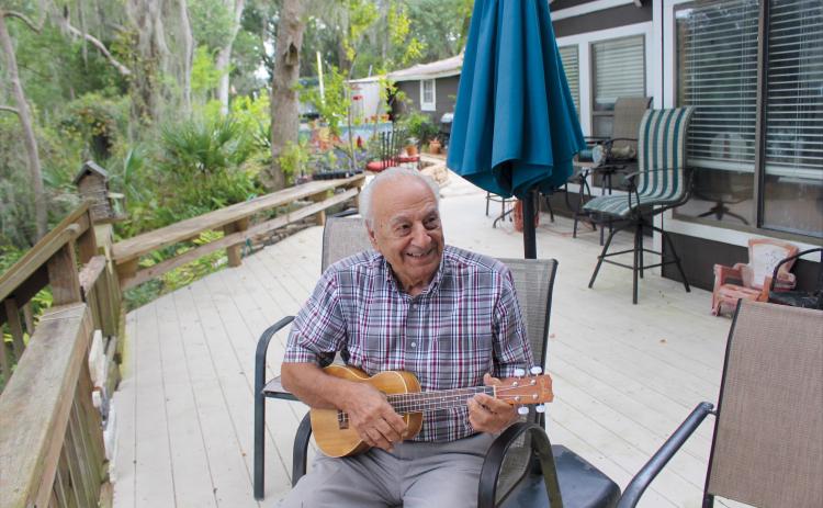 George Crady, 94, plays his ukulele and sings at his home on Crady Lake on Oct. 1.  Marisa DeMar/News-Leader 