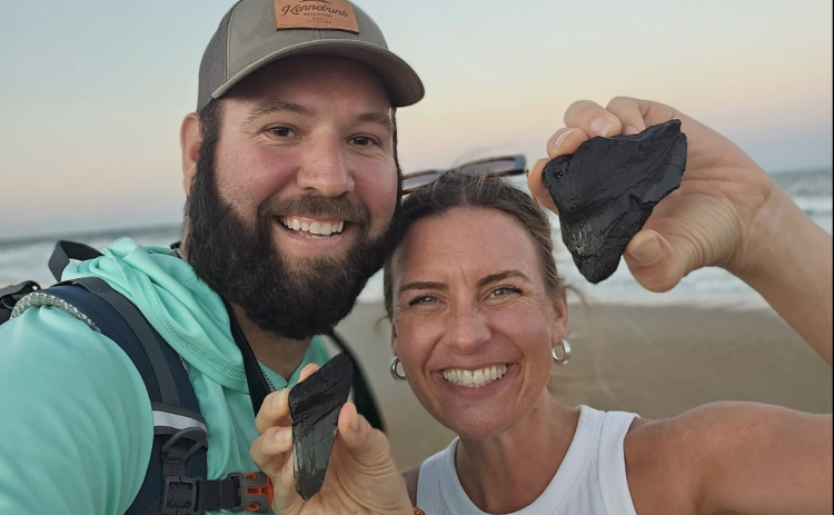 Matt and Alice Henry hold their megalodon pieces found near the North Beach Access Point in Fernandina Beach on Sept. 16.  Submitted by Matt Henry 