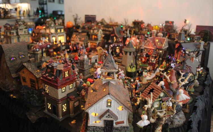 Barb Looney’s Halloween village aligned across her dining room and living room space. By Marisa DeMar/News-Leader