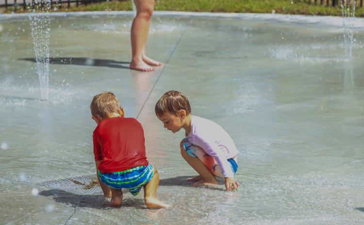 Cooper Trout, left, and Asher Sereda play at the splash pad Sept. 26 after its official opening. The two have been anxiously awaiting its opening, their mothers Michele and Halee told the News-Leader. Photo by Ashley Chandler/News-Leader