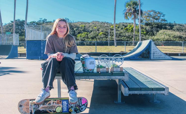 Coco Waldo, 11, with her trophies from the Exposure Skate competition at Poe Pinson Skate Park Fernandina Beach on Tuesday. Photo by Marisa DeMar/News-Leader