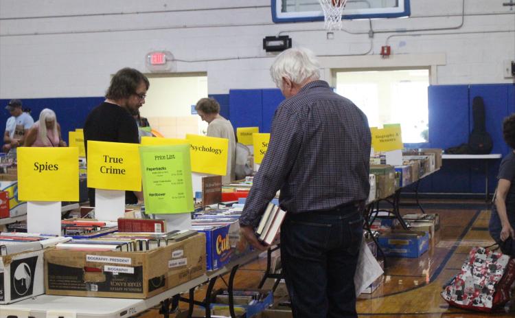Readers browse the book sale hosted by the Friends of the Fernandina Beach Library in the Peck Center Gymnasium on Nov. 6. By Marisa DeMar/News-Leader