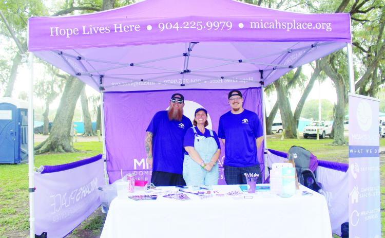 Micah's Place board members Tracie Fasel, Robby Whitley, Chaz Skarpalezos at their tent on Community Care Day on Saturday.  By Marisa DeMar/News-Leader