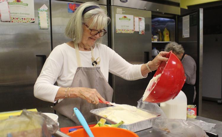 Photos by Marisa DeMar/News-Leader  Volunteers at Gracie’s Kitchen prepare a meal for their drive-up meal service on Thursday, Nov. 13. 