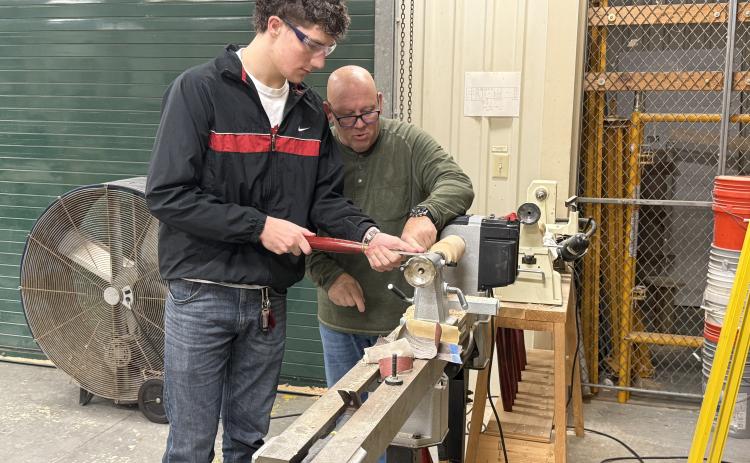 Nick Blank/News-Leader  Luke Gray uses a lathe as Yulee High School instructor Ray Hart watches.