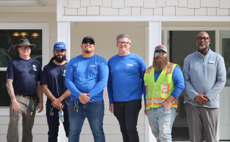 Octavious Carr the Vice President of Construction for First Coast Habitat for Humanity and the crew at the new home they built in Fernandina Beach. By Marisa DeMar/News-Leader 
