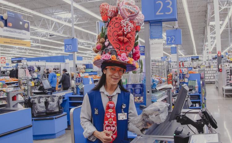 Marlon (Maui) Capule wears a homemade Valentine’s Day themed hat while working as a cashier at Walmart in Yulee on Wednesday. 