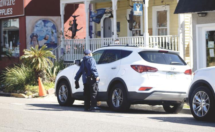 One Parking employee checks cars in the premium parking zone on Feb. 23. By Marisa DeMar/News-Leader