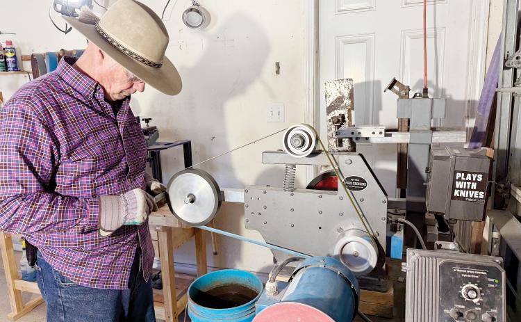 Knifemaker John Thompson grinds a knife in his workshop. Nick Blank/News-Leader