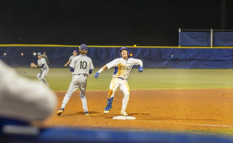 Dalton Janey celebrates as he reaches third base on a triple in a game against Sandalwood on Feb. 17. Photo by Ashley Chandler/News-Leader