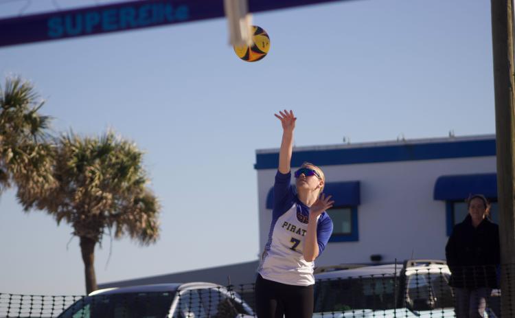 Fernandina Beach’s Olivia Rousselow serves the ball in a beach volleyball match Monday against Clay. Photo by Marisa DeMar/News-Leader