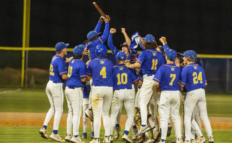 The Pirates celebrate earning the district title last week. Photo by Ashley Chandler/News-Leader