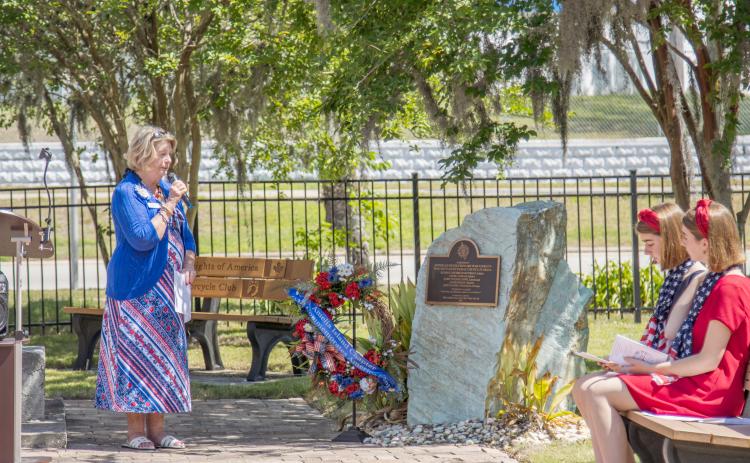 Diane Hishta, left, regent for the Amelia Island Chapter of the National Society Daughters of American Revolution, leads the wreath-laying ceremony Saturday at the Veterans Memorial at Central Park in Fernandina Beach. Photo by Ashley Chandler/News-Leader