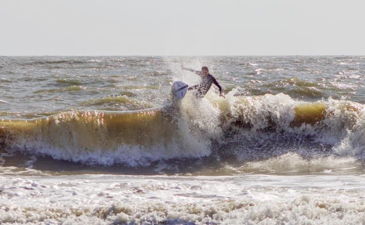 Surfers Aiden Flynn, CJ Rogers and Noah Poteat were out on the water Sunday at Main Beach. Photo by Marisa DeMar/News-Leader