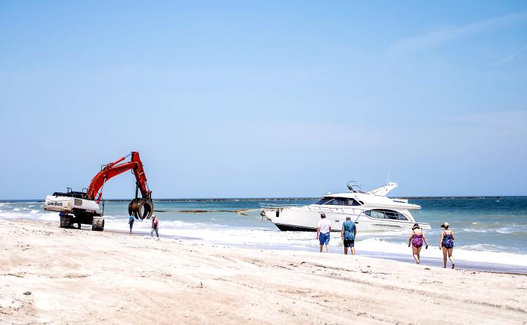 Maverick Marine Services brings the vessel, Coco, onto the beach on Fernandina Beach near Beach Access 16N.  Nick Blank/News-Leader