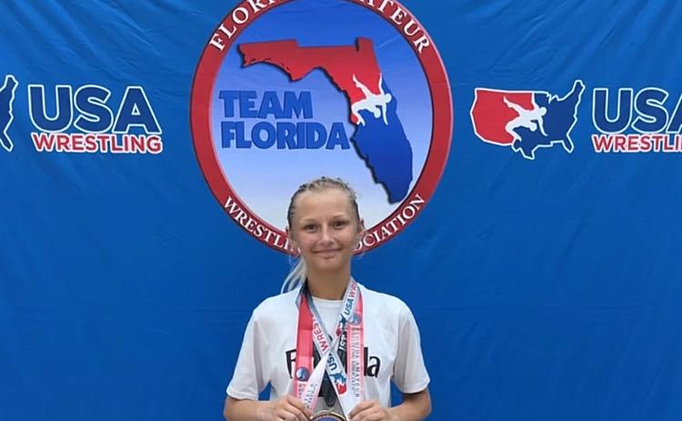 Journey Flannery shows off her hardware after winning two of her three divisions at at the Father Devine National Team Qualifier & Championship and making Team Florida. Submitted photo
