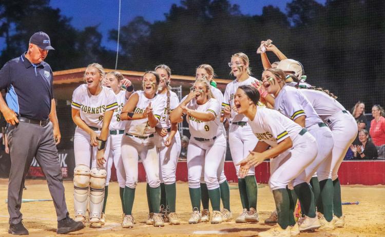 Lady Hornet softball players await Carmen Overstreet at home plate after she knocked a homerun in Wednesday’s regional tournament win over the West Nassau Warriors.Photo by Amanda Bishop/Nassau County Record