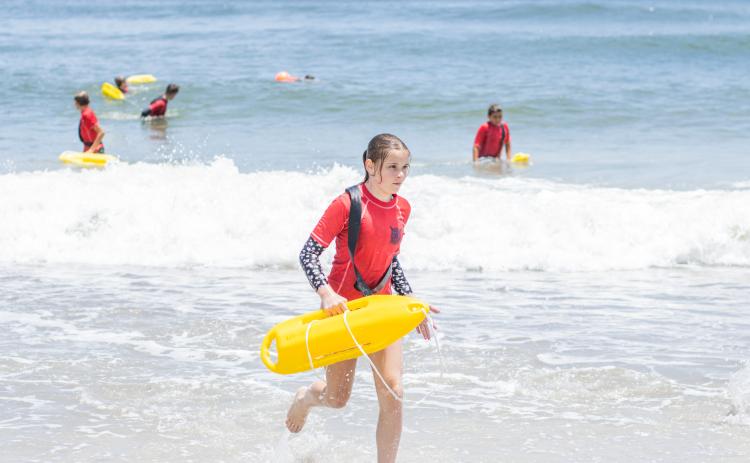 Participants of the Junior Lifeguard Camp take park in an exercise Wednesday at Seaside Park. The first weeklong session of the camp was held this week. Photo by Ashley Chandler/News-Leader