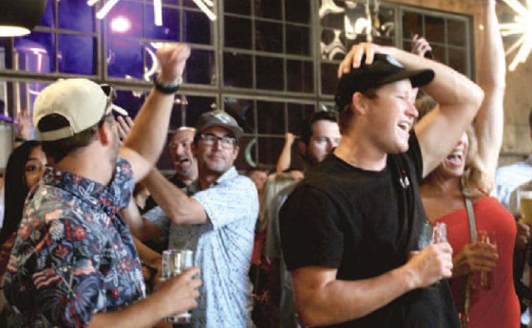 Fans celebrate a U.S. goal on Friday while watching the US Men’s National Team play Australia in a World Cup group stage match.