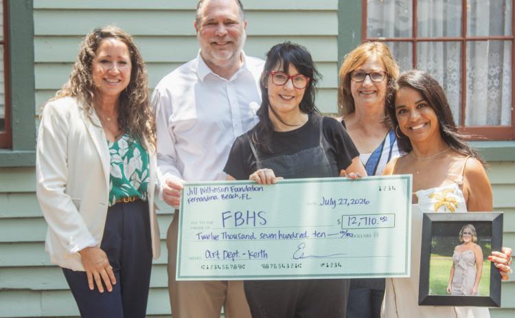The fourth annual Fernandina Beach Art Department fundraiser and silent auction raised nearly $13,000 for the school program. From left, Antoinette Ferry, Todd McDonald, Joy Keith, Diane Smith and Esmerelda McDonald pose with and a photo of Jill Wilkinson and the ceremonial check presented to Keith for the Fernandina Beach Art Department. Photo by Ashley Chandler/News-Leader