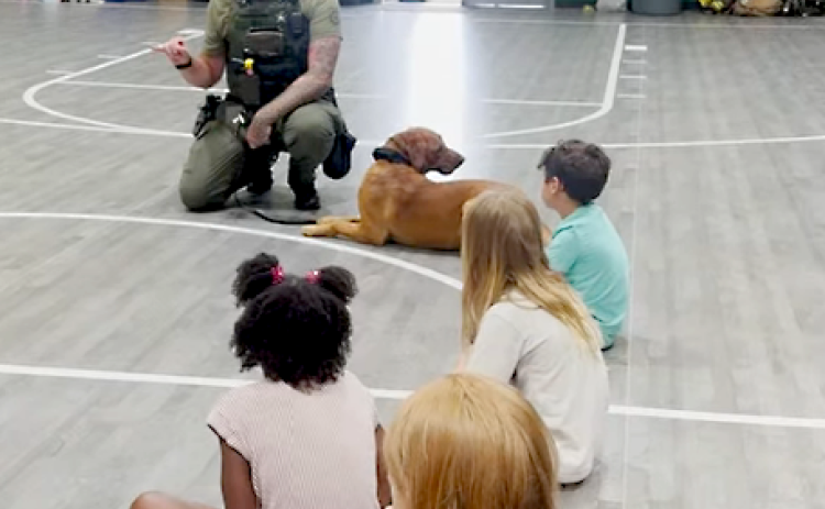 A deputy speaks to children at the radKIDS camp in Yulee. Submitted photo