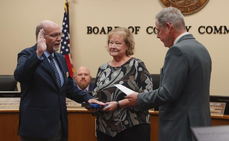 Commissioner John Martin is sworn in for another term in December 2024. From left, Martin, his wife Donna and Commissioner A.M. “Hupp” Huppmann. Photo by Ashley Chandler/News-Leader