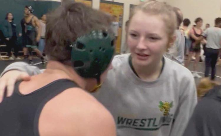 Journey Flannery, right, talks to Lucas Flannery between matches at a high school wrestling meet. Submitted