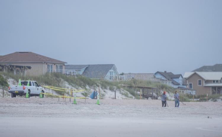 Nassau County staff rakes the sand between a sea turtle nest and the ocean on July 22 on American Beach. The county’s beach raking program was put in place in an effort to avoid the potential negative impacts of tire tracks on new sea turtle hatchlings.