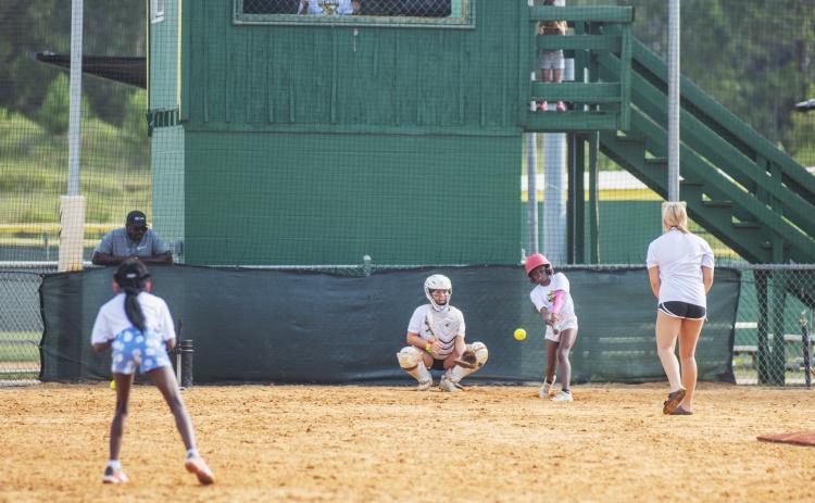 A Yulee High School Softball Camp participant takes a swing at pitch Thursday morning. Photo by Ashley Chandler/News-Leader