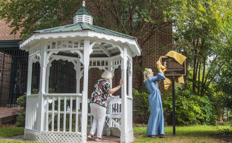 Lynn Leisy, president of the Princess Amelia Chapter of the Florida Society of the Colonial Dames XVII Century, and distant cousin to Amelia, unveils the Princess Amelia historical marker Saturday, now outside the Amelia Island Museum of History. Photo by Ashley Chandler/News-Leader
