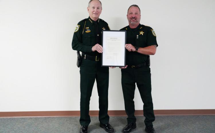 From left, Nassau County Sheriff Bill Leeper  and Undersheriff Jon Hooper pose with a proclamation Monday recognizing the Nassau County Sheriff’s Office’s 200th anniversary.