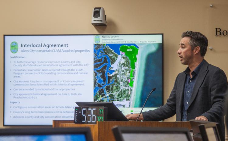 Nassau County Conservation Land Manager Taylor Clem speaks at the July 27 BOCC meeting about the Interlocal Agreement between Nassau County and the City Fernandina Beach that passes maintenance responsibility of certain CLAM properties purchased in city limits to the Fernandina Beach government. Photo by Ashley Chandler/News-Leader