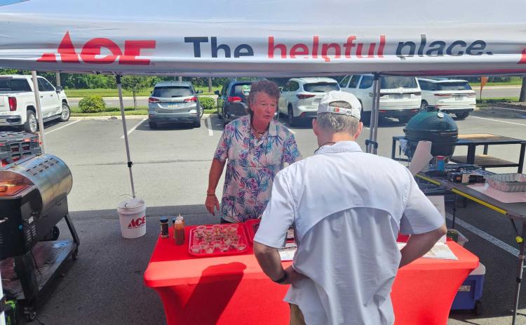 Greg Edwards, owner of Amelia Island BBQ Company, talks with a Turner ACE Hardware customer Saturday. Photo by Suzi Hamilton/For the News-Leader