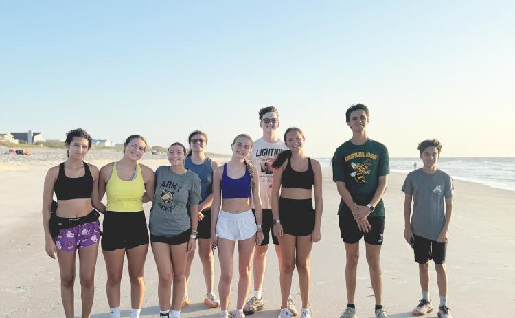 YHS boys and girls cross country runners during a summer training session on the beach. Courtesy of YHS cross country