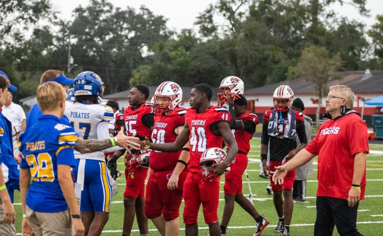 Nassau County and Duval County school officials coordinate the pregame handshake Friday between the Fernandina Beach High School and Andrew Jackson High School varsity football teams. Nick Blank/News-Leader