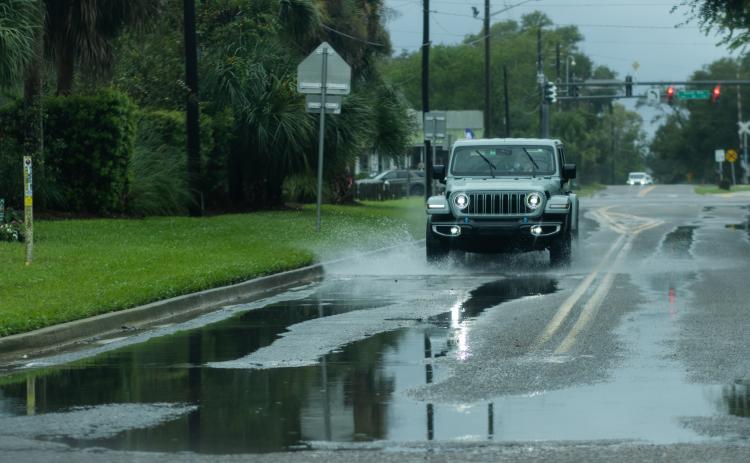 A driver splashes through a puddle on Lime Street in Fernandina Beach. Ashley Chandler/News-Leader