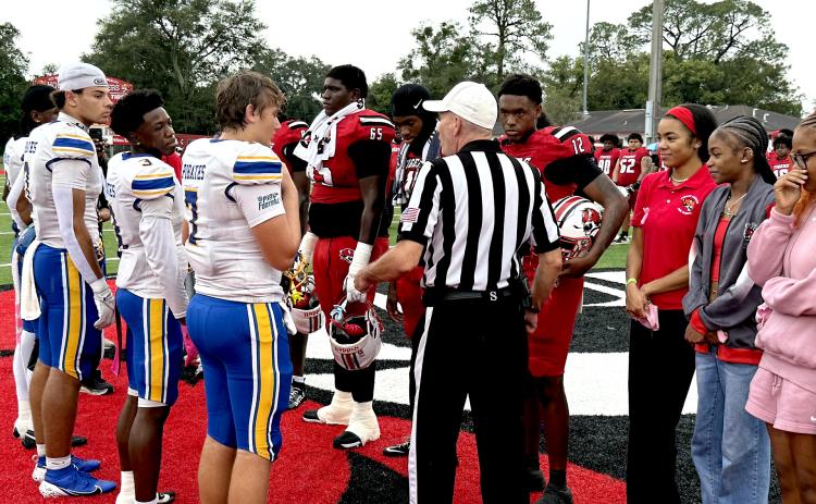 Fernandina Beach High School and Andrew Jackson High School football players greet each other at midfield, exchanging handshakes before Friday’s game. photo by Nick Blank/News-Leader