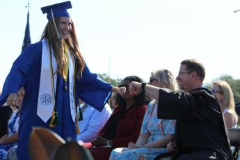 Fernandina Beach High School graduate Kallie Johns acknowledges Teacher of the Year James Glacklin before collecting her diploma Saturday morning.