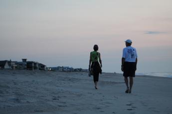 Volunteers Jan and Eric Linden walk Sadler Beach before the sun has risen, keeping an eye out for turtle tracks leading to a nest.