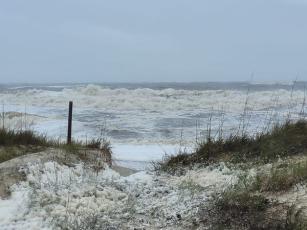 High winds and storm surge produced voluminous sea foam and rough surf on Amelia Island, but the barrier dune was not breached.