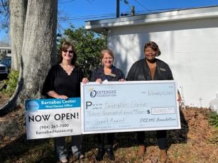 Ramona Jones, trustee with The Okefenoke Rural Electric Membership Corporation Foundation, presents a grant award to Barnabas Chief Development Officer Tania Yount and Callahan Office Empowerment Program Coordinator Joyce Knox. Submitted photo