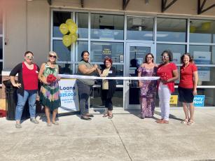 At the recent ribbon cutting ceremony for Advance America, holding the scissors is Lyntrell O’Neal, Center Sales Manager, left, and Jennifer Adkins, Consumer Lending Specialist. Submitted photo