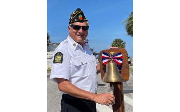 Steve Bradshaw, commander of American Legion Post 54, checks the bell that will be rung after Amelia Island Chapter Daughters of the American Revolution reads the name of each Nassau County resident who gave his life for his country. Submitted photo