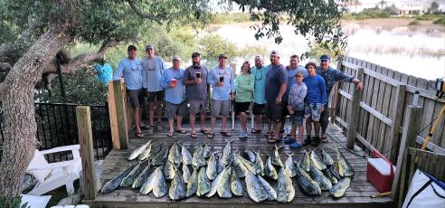 Steve Pickett and his family and friends are pictured with a big catch of hard-fighting, colorful and delicious blue water dolphin. Submitted photo