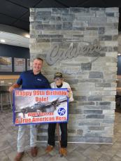 Dale Stickrath and Culver’s Yulee owner Marty Greye with the banner that Culver’s had made. Photo by Sean Mathew Rosenthal/News-Leader