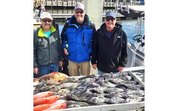 Thad Carter, Zach Terry and Mallory Smith, top from left, are pictured with a big catch of sea bass and more while fishing with Capt. Allen Mills aboard the fishing charter boat Wahoo.  Submitted photo